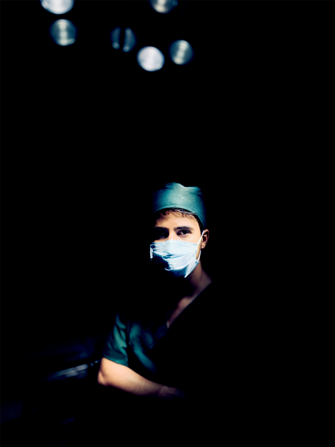 Surgeon in gown and face mask